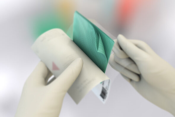 Person opening the inner packaging of a Sorbact Compress dressing.